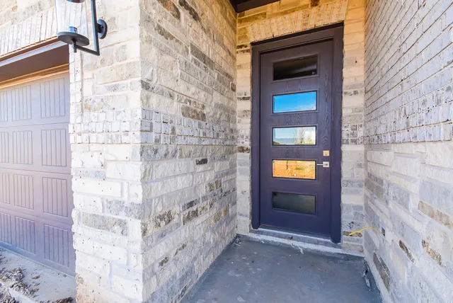 a bathroom with a door and a shower