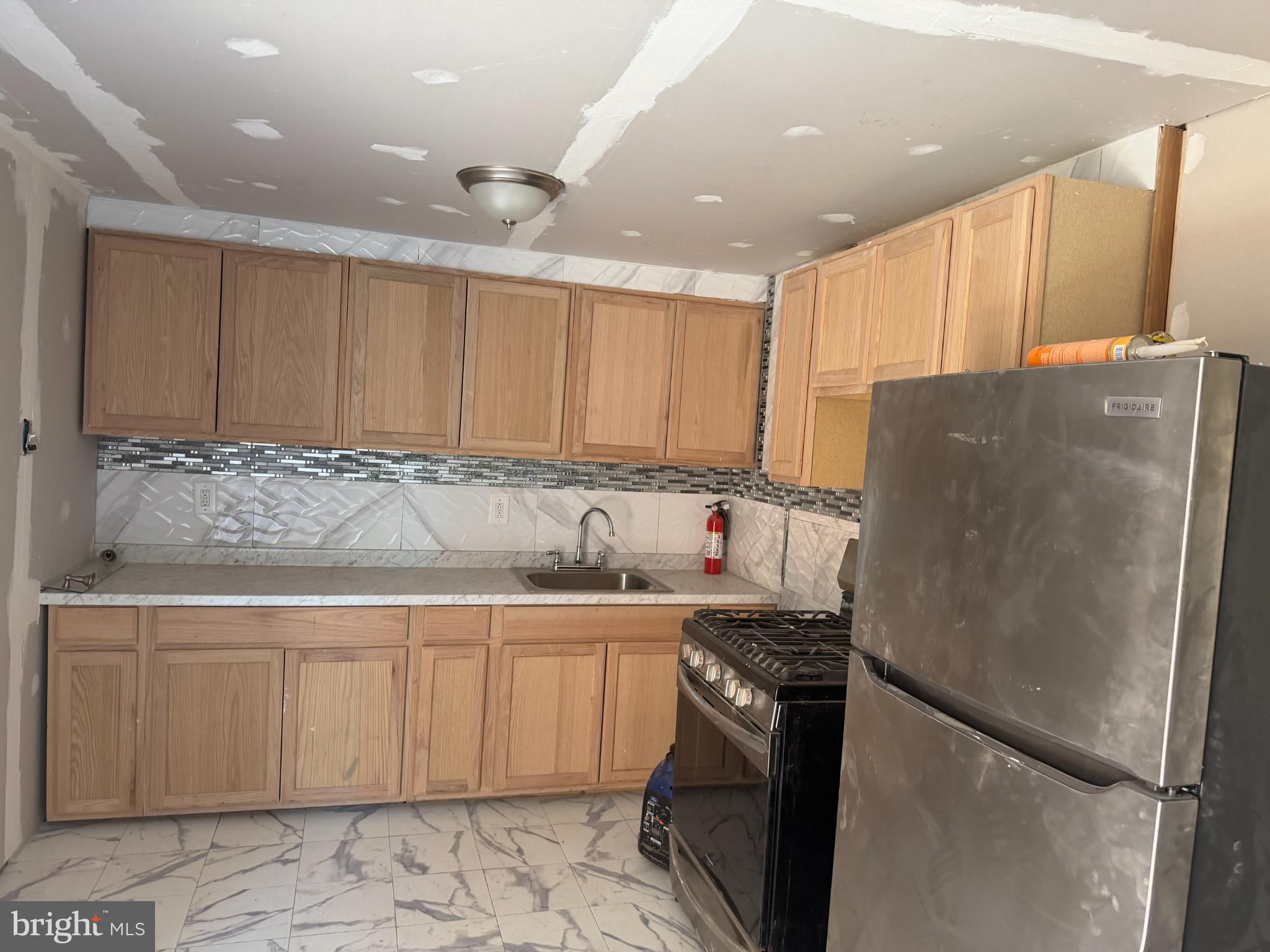 1410 Pennington Road Trenton, NJ 08618 - Photo 11 of 15 a kitchen with stainless steel appliances granite countertop a refrigerator and a sink