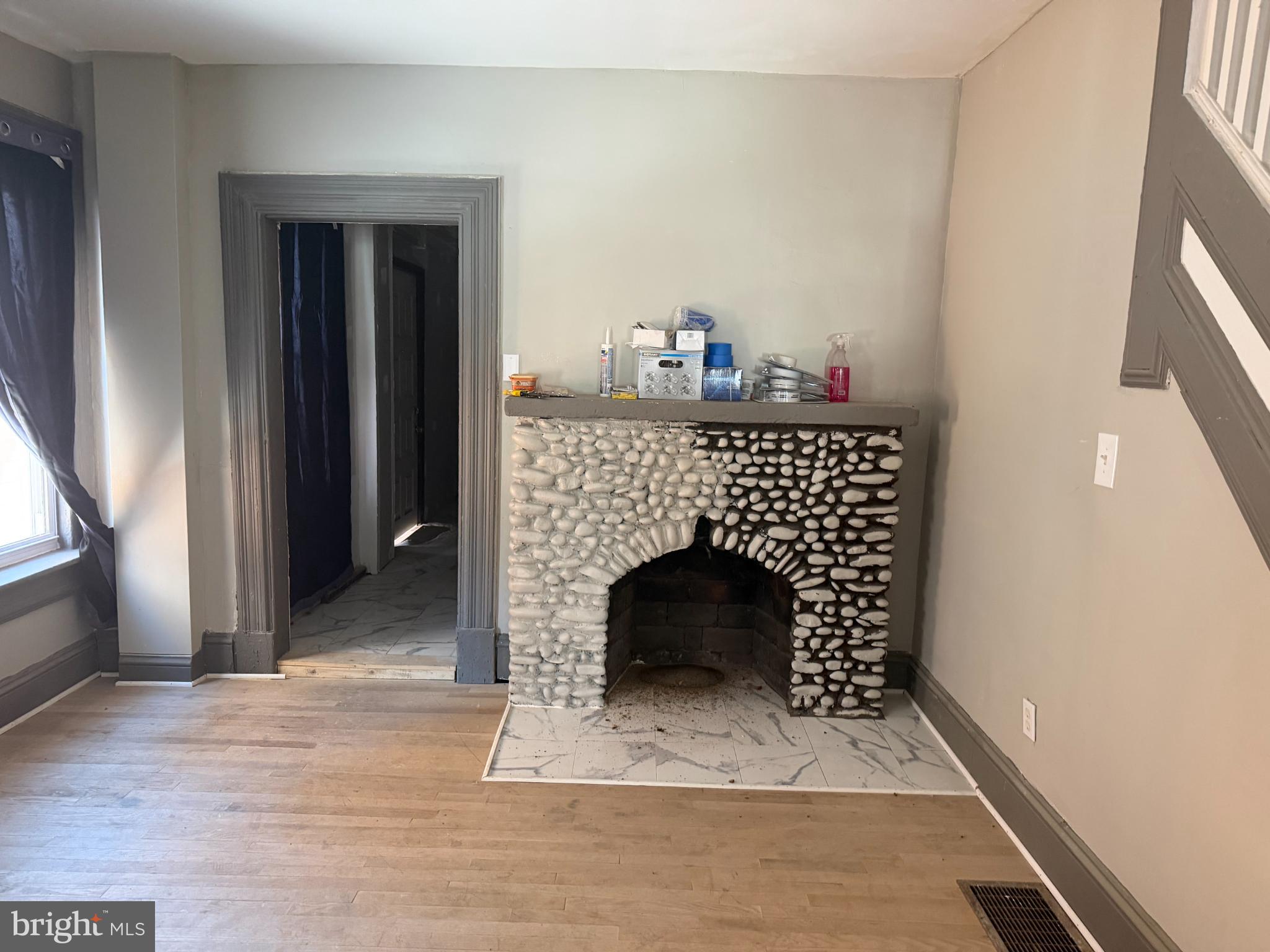1410 Pennington Road Trenton, NJ 08618 - Photo 13 of 15 a living room with a fireplace and a wooden floor