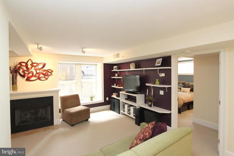 1750 16th Street Northwest, Unit 4 Washington, DC 20009 - Photo 5 of 20 a living room with furniture and a fireplace