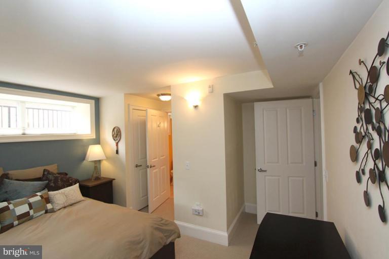1750 16th Street Northwest, Unit 4 Washington, DC 20009 - Photo 9 of 20 a bedroom with a bed and a lamp with window