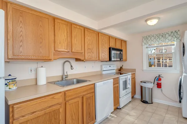 a large kitchen with a large window and cabinets