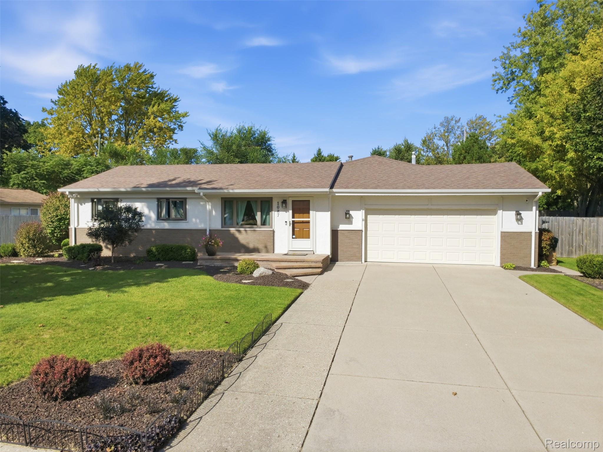 1087 Collingwood Drive Rochester, MI 48307 - Photo 1 of 56 Single-story residence featuring a two-car garage, concrete driveway, and front landscaping
