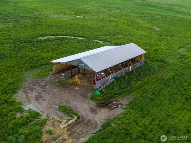 a aerial view of a house with a yard table and chairs
