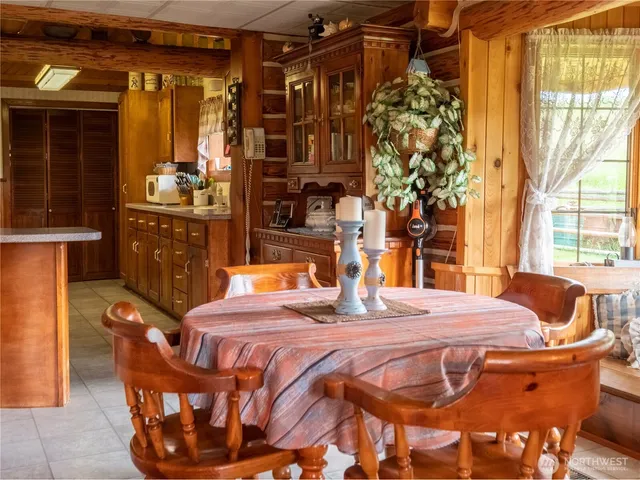 a dining room with furniture and window
