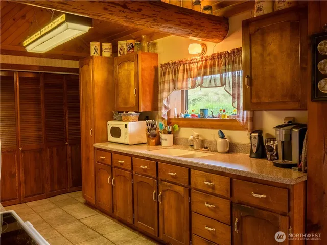a bathroom with a double vanity sink and a window