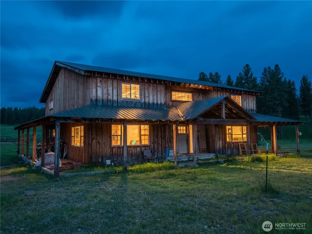 a view of house with a big yard and potted plants