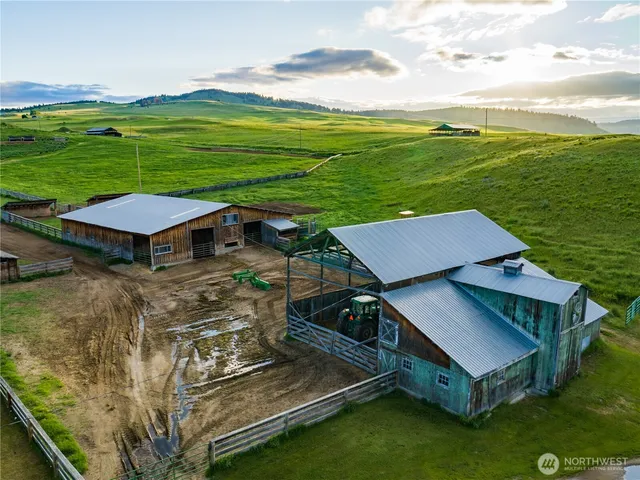 an aerial view of a house with big yard