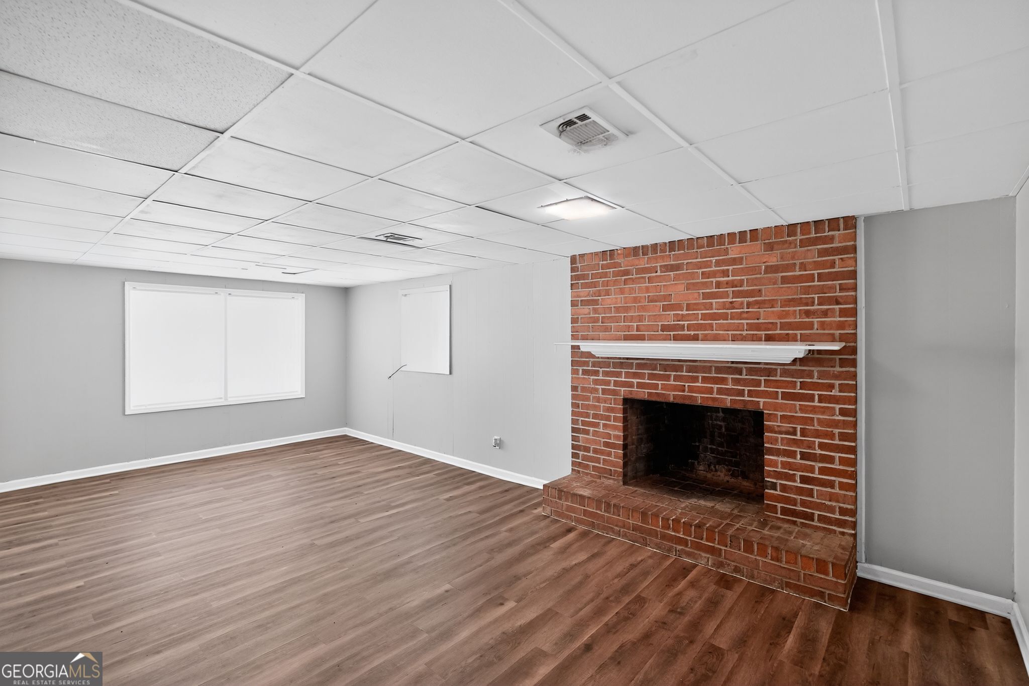1071 Luther Drive Southwest Mableton, GA 30126 - Photo 11 of 27 a view of an empty room with wooden floor fireplace and a window
