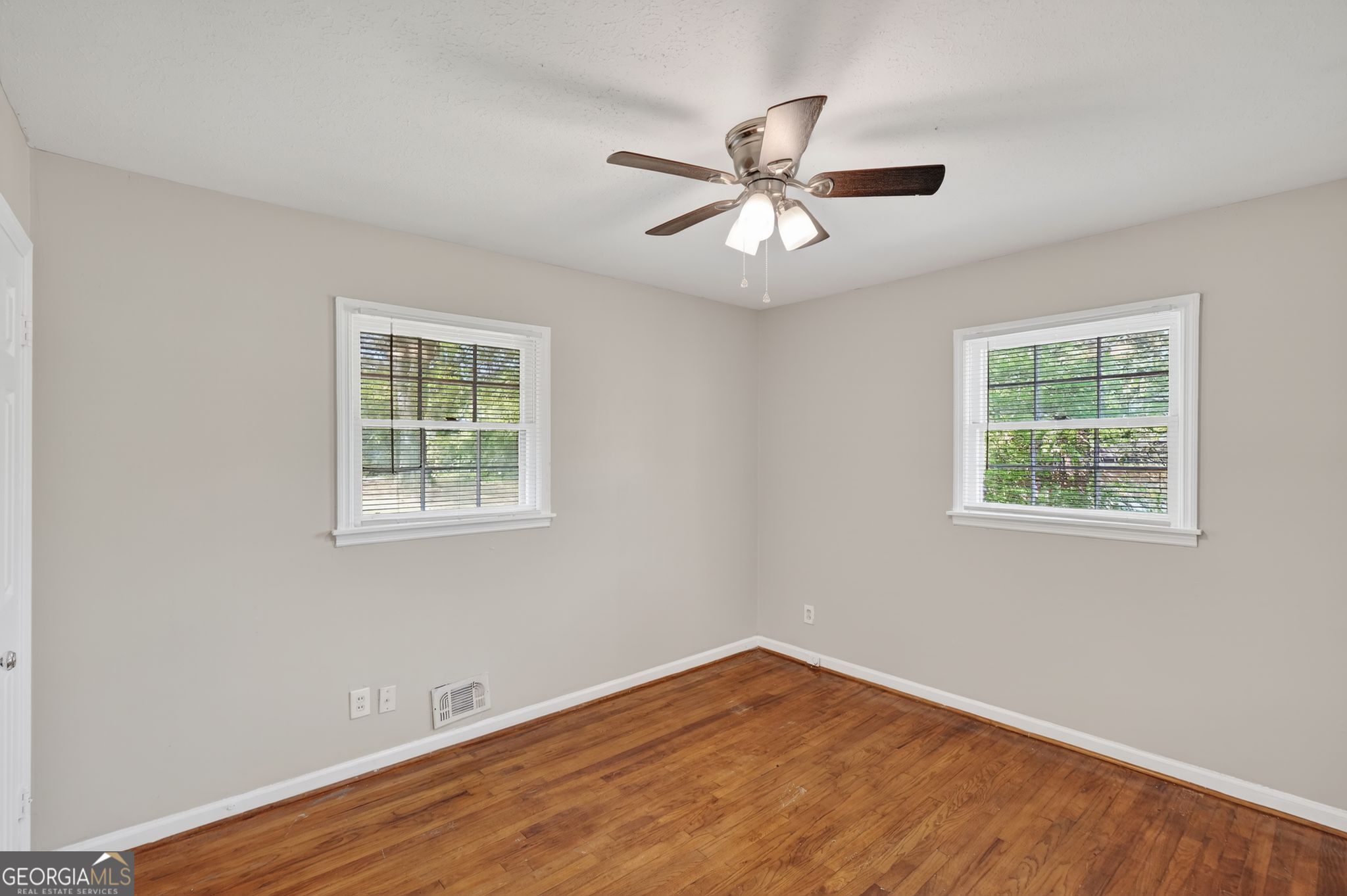 1071 Luther Drive Southwest Mableton, GA 30126 - Photo 12 of 27 a view of an empty room with wooden floor and a window