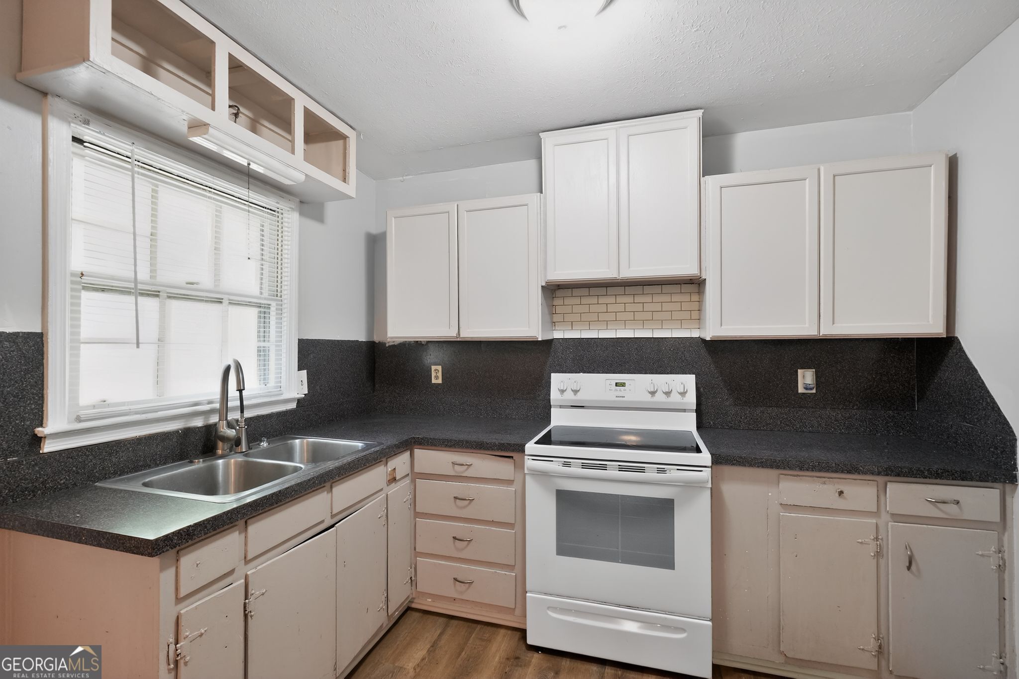 1071 Luther Drive Southwest Mableton, GA 30126 - Photo 14 of 27 a kitchen with cabinets appliances a sink and a window