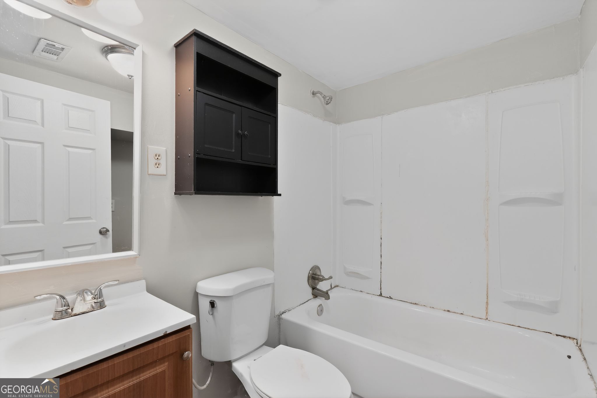1071 Luther Drive Southwest Mableton, GA 30126 - Photo 20 of 27 a bathroom with a bathtub shower sink vanity and toilet