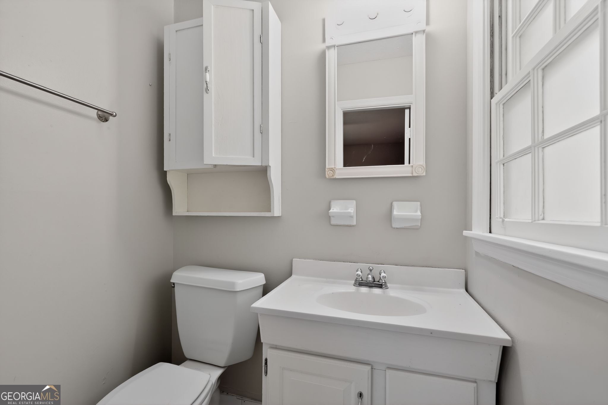 1071 Luther Drive Southwest Mableton, GA 30126 - Photo 21 of 27 a bathroom with a toilet a sink and mirror