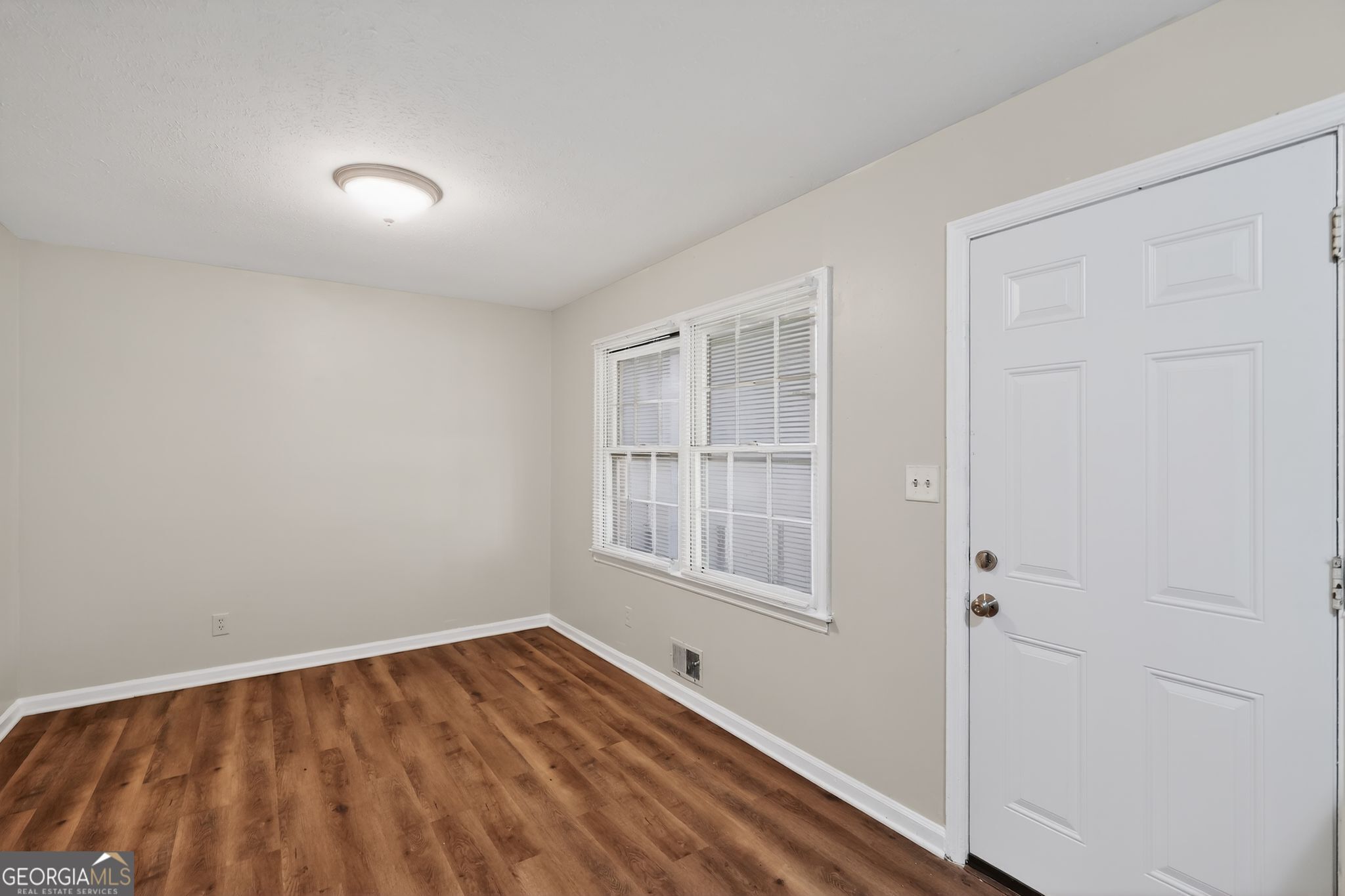 1071 Luther Drive Southwest Mableton, GA 30126 - Photo 4 of 27 a view of empty room with wooden floor and fan
