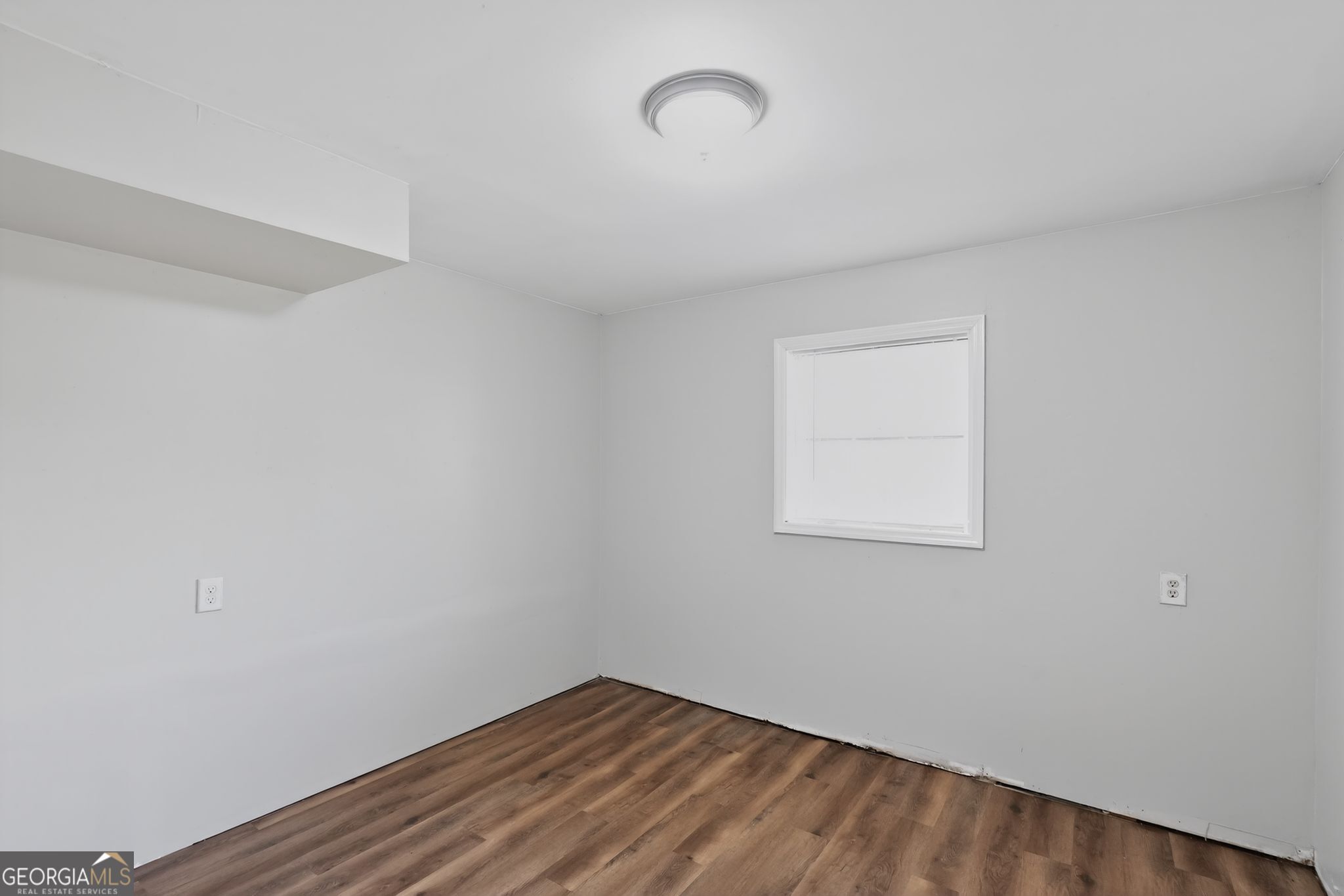 1071 Luther Drive Southwest Mableton, GA 30126 - Photo 5 of 27 a view of an empty room with wooden floor and a window