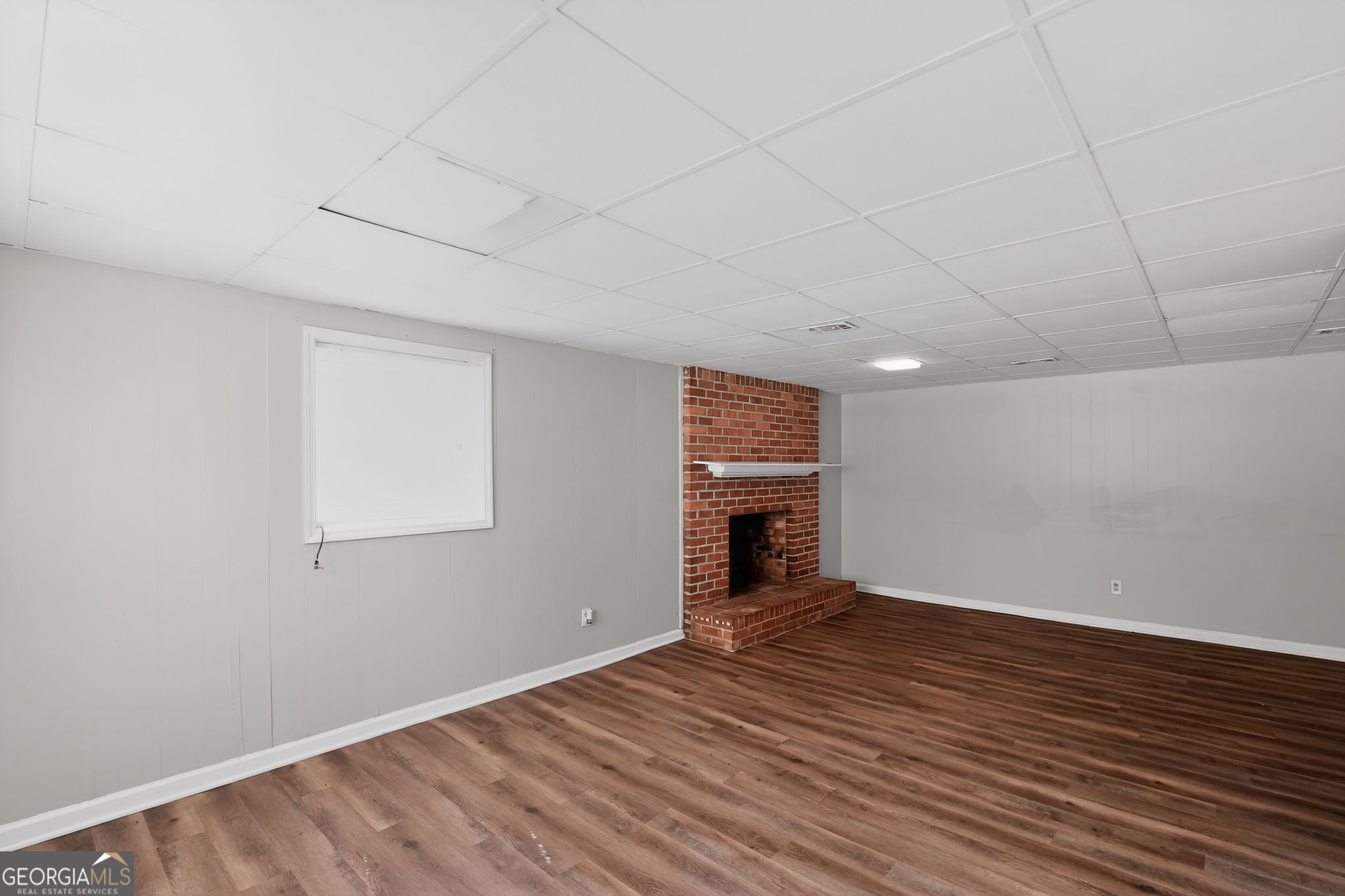 1071 Luther Drive Southwest Mableton, GA 30126 - Photo 7 of 27 a view of empty room with wooden floor and fireplace