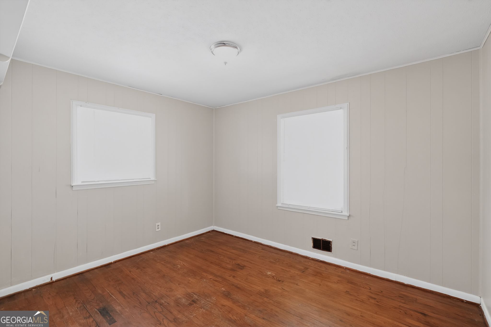 1071 Luther Drive Southwest Mableton, GA 30126 - Photo 8 of 27 a view of an empty room with wooden floor and a window