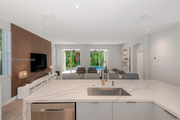 a kitchen with a stove a sink and a refrigerator