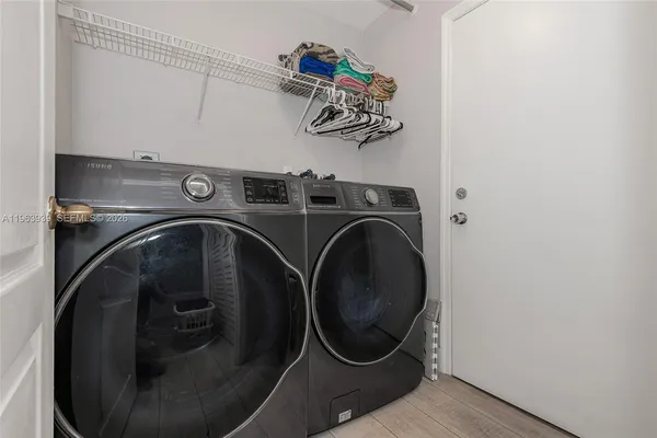a large bed sitting in a bedroom next to a window and a flat screen tv