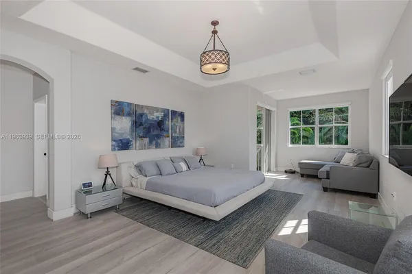 a living room with furniture and a wooden floor