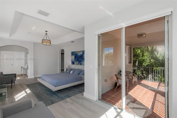 a bedroom with a bed and painting on the wall