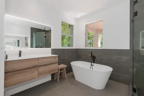 a bathroom with a double vanity sink toilet and shower