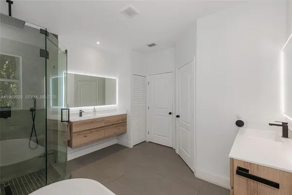 a bedroom with a large bed and a large window