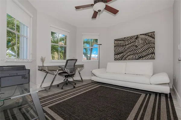 a view of a house with a swimming pool and sitting area