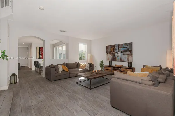 a view of a dining room with furniture and wooden floor