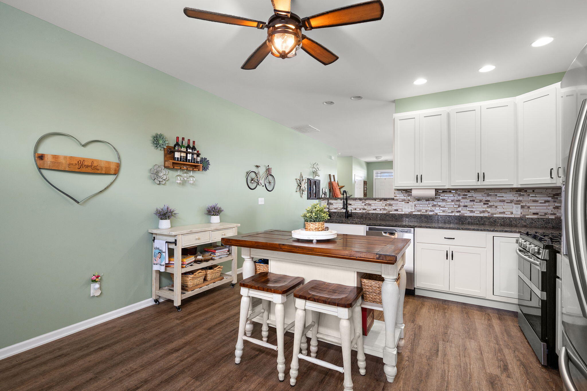 1171 Weaver Way Chesterton, IN 46304 - Photo 12 of 25 a kitchen with a dining table chairs cabinets and wooden floor