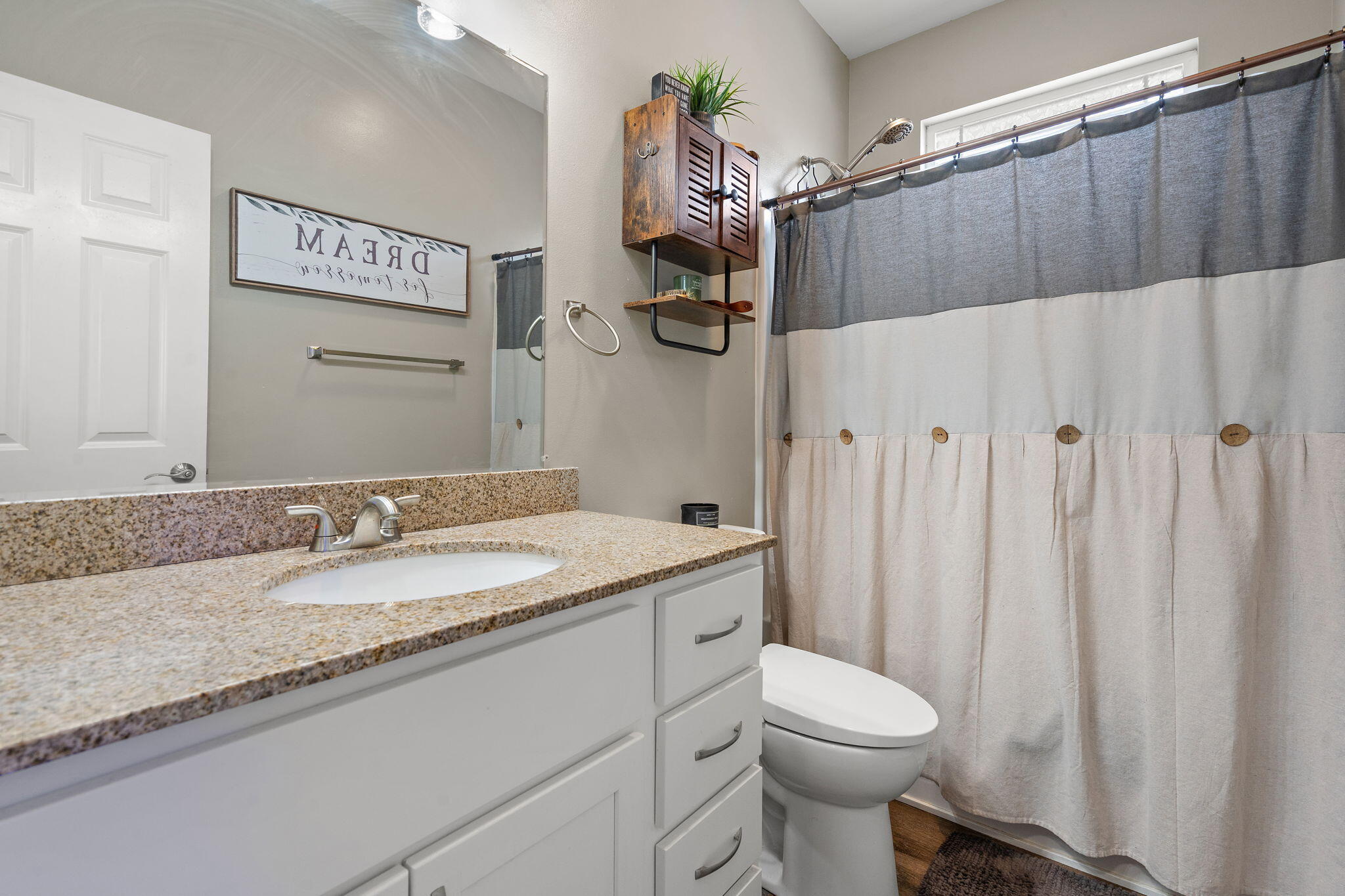 1171 Weaver Way Chesterton, IN 46304 - Photo 17 of 25 a bathroom with a granite countertop sink a toilet and a mirror
