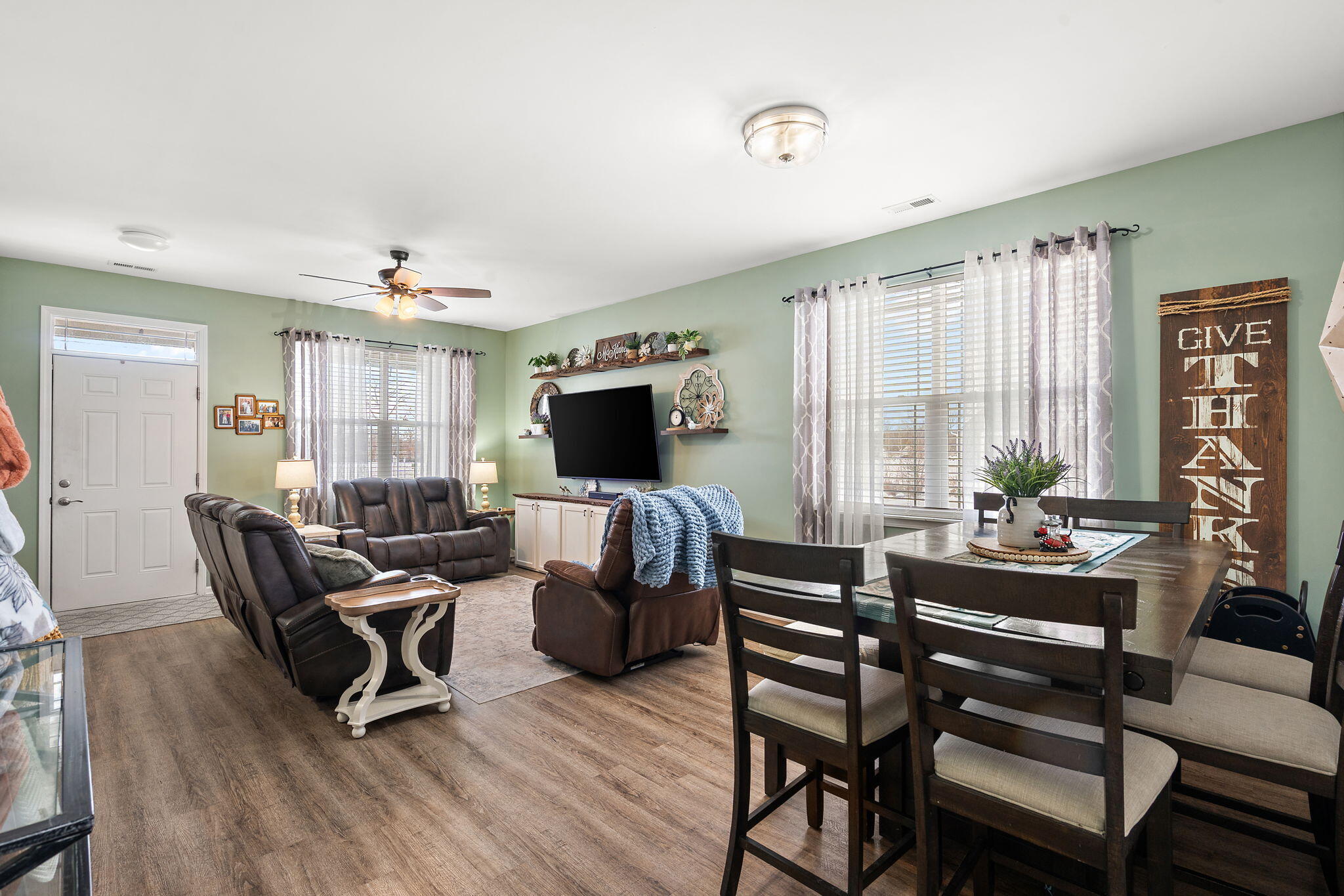1171 Weaver Way Chesterton, IN 46304 - Photo 8 of 25 a living room with furniture a flat screen tv and a large window