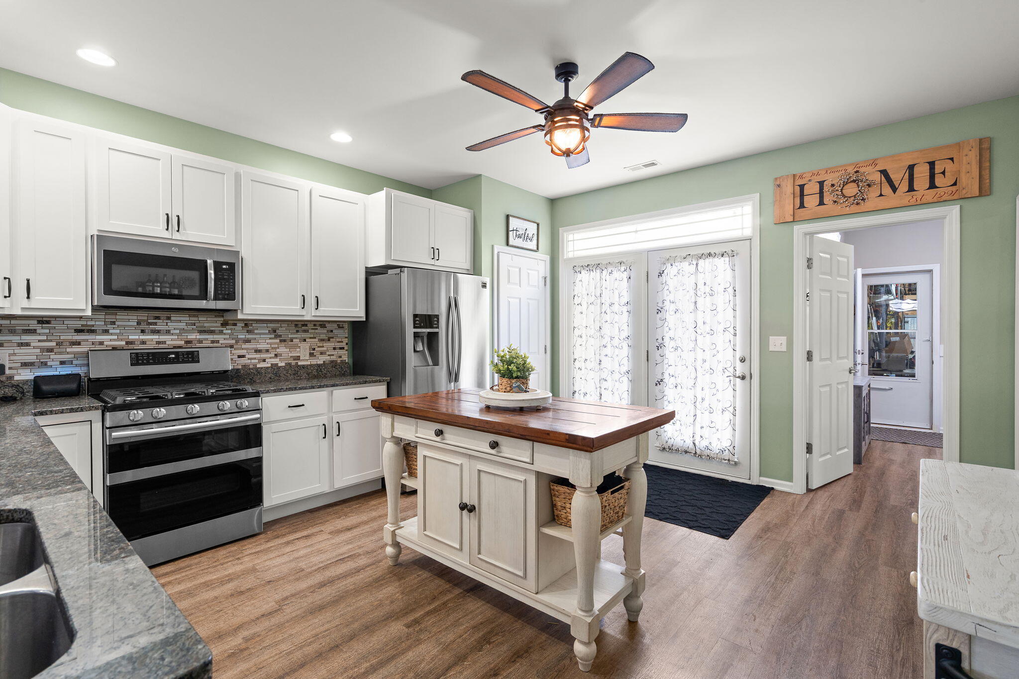1171 Weaver Way Chesterton, IN 46304 - Photo 9 of 25 a kitchen with stainless steel appliances granite countertop a stove a sink dishwasher a refrigerator white cabinets and wooden floor