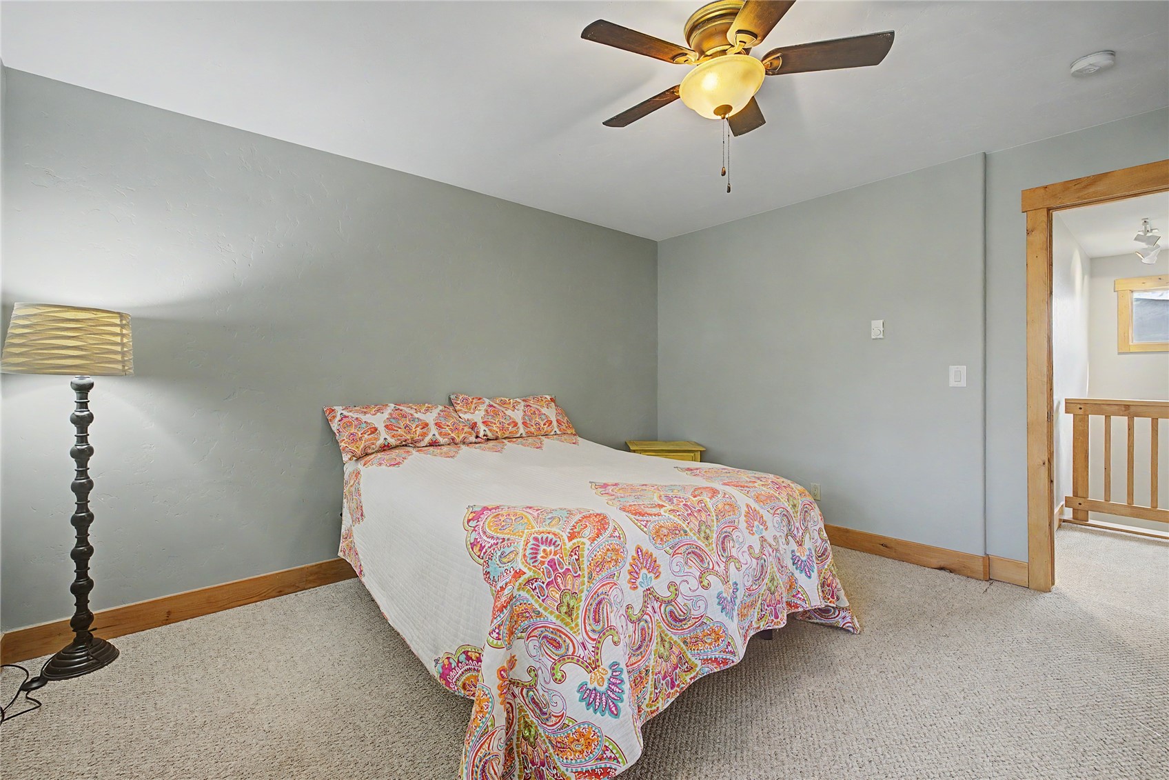 6726 Ryan Gulch Road, Unit 6726 Wildernest, CO 80498 - Photo 30 of 39 a bedroom with a bed and a chandelier fan