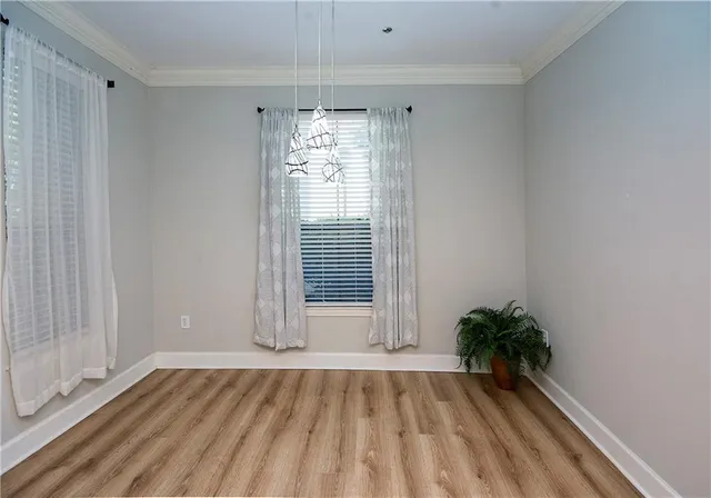 a view of a porch with a table and chairs and potted plants