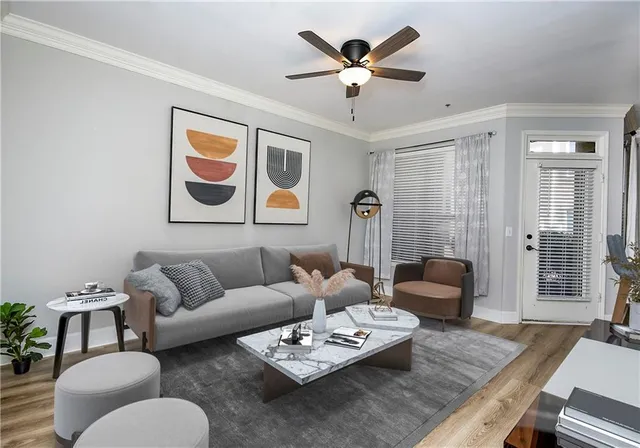 a living room with furniture and a chandelier