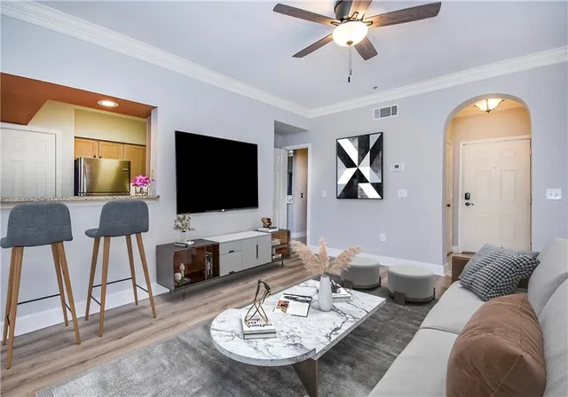 a living room with furniture and a flat screen tv