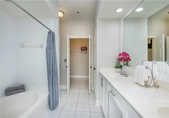 a bathroom with a tub sink and mirror