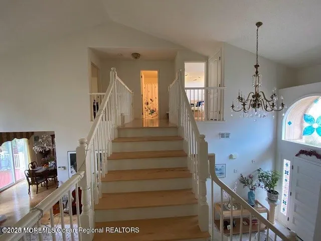 a view of living room with furniture and a chandelier