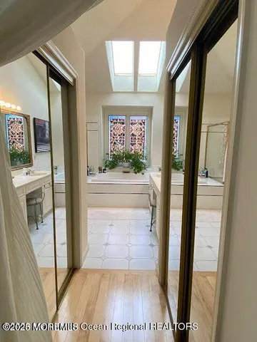 a bedroom with a bed and a dresser next to a window