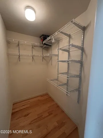 a view of empty room with a fireplace and a window