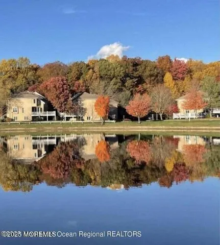 a view of a dining room with furniture a chandelier and wooden floor
