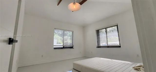 a bathroom with a window and a chandelier