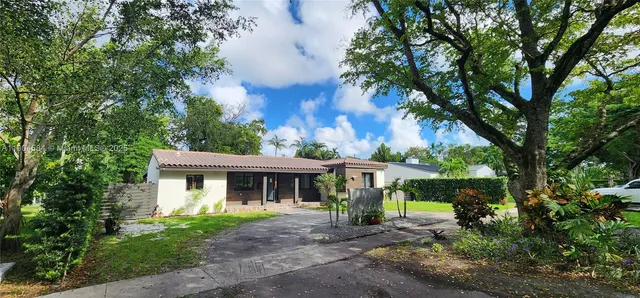 a front view of a house with garden and porch