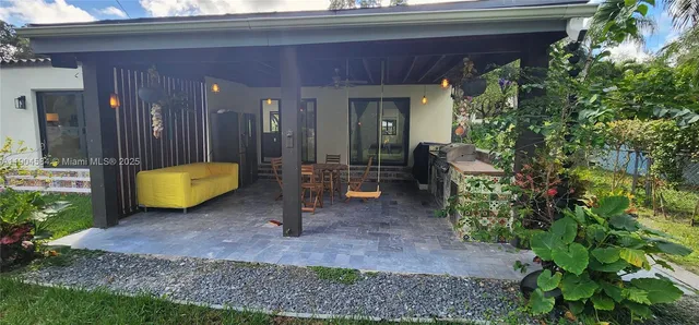 a view of a porch with furniture and a potted plant