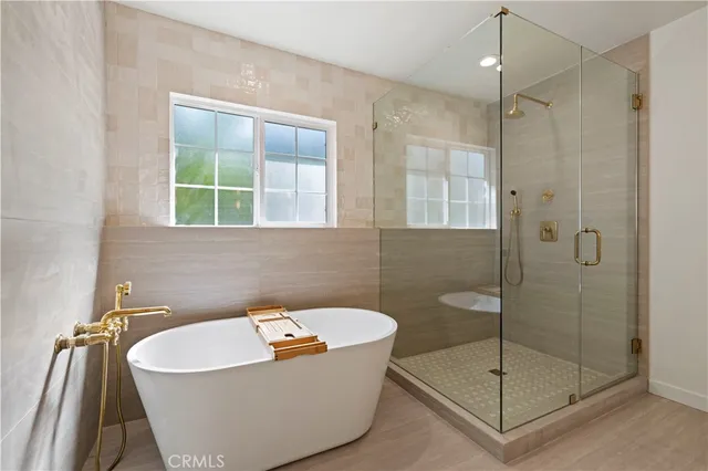 a white bath tub sitting next to a shower