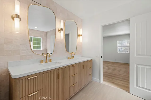 a bathroom with a double vanity sink and a mirror
