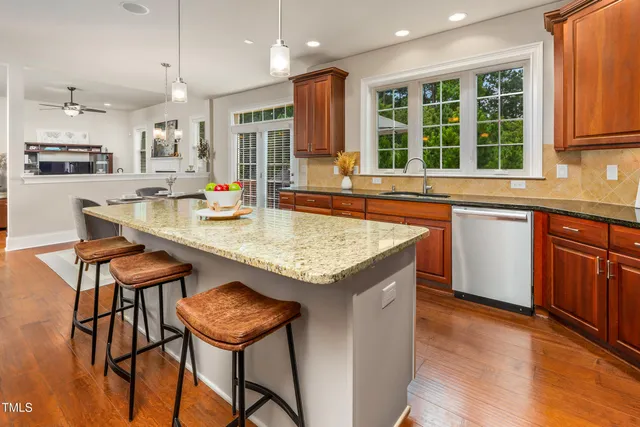 a dining table with chairs and cabinets