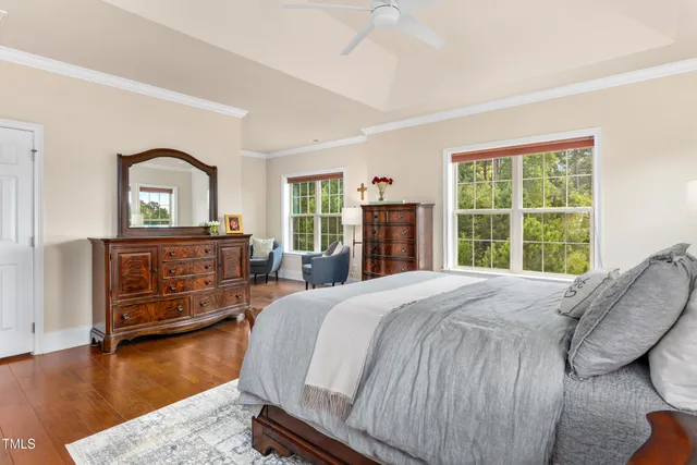a bedroom with a bed and a dresser next to a window