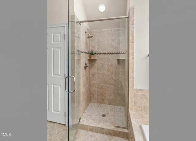 a bathroom with a glass shower door
